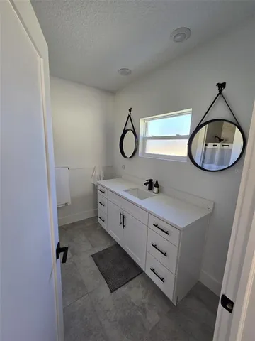 a bathroom with a double vanity sink and a mirror