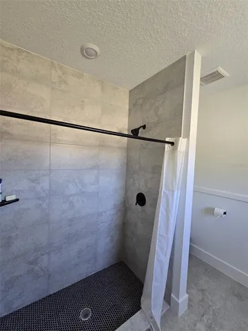 a bathroom with a glass shower door