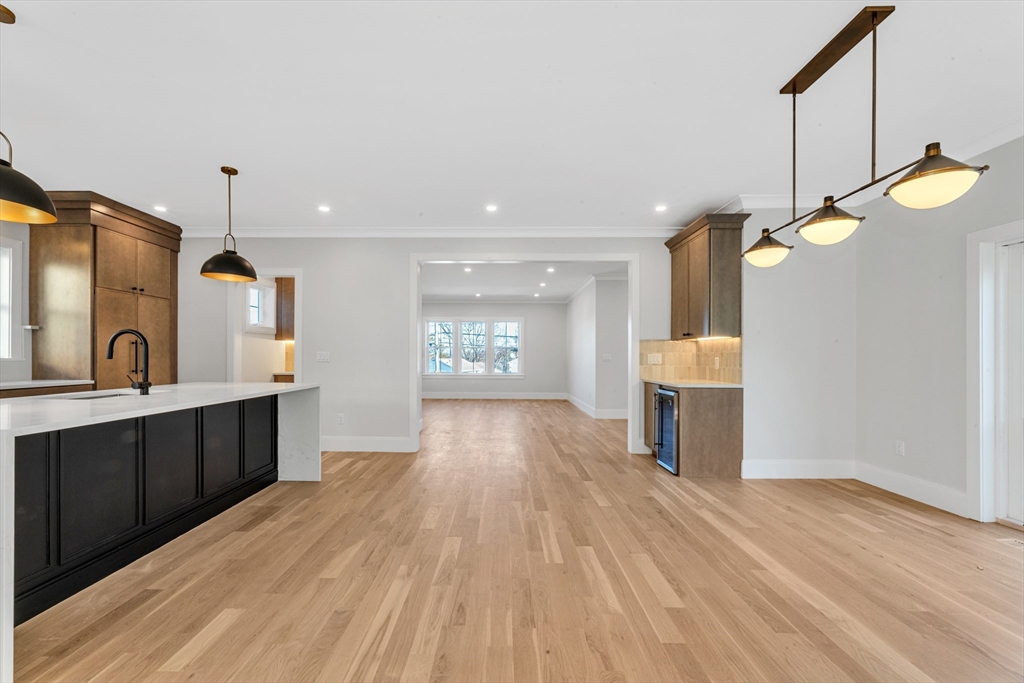 415 Poplar Street Boston, MA 02131 - Photo 11 of 31 a view of a kitchen center island wooden floor and windows