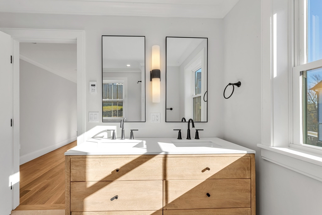 415 Poplar Street Boston, MA 02131 - Photo 17 of 31 a bathroom with a tub sink and mirror