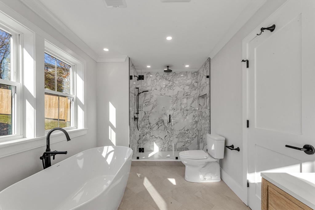 415 Poplar Street Boston, MA 02131 - Photo 18 of 31 a spacious bathroom with a bathtub shower sink mirror and toilet