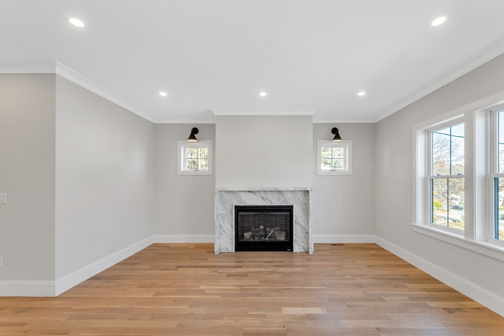 415 Poplar Street Boston, MA 02131 - Photo 3 of 31 a view of an empty room with a fireplace and a window