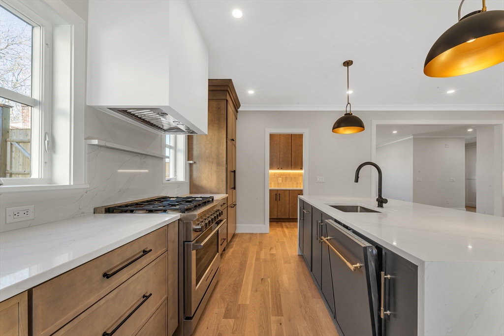 415 Poplar Street Boston, MA 02131 - Photo 8 of 31 a kitchen with a sink and a stove top oven