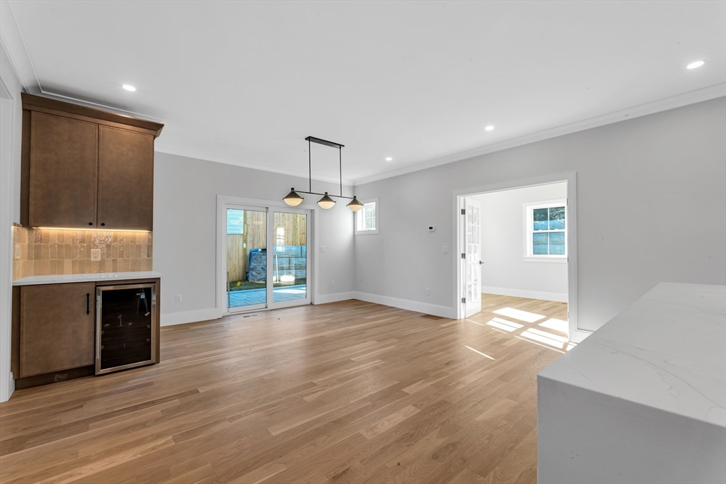 415 Poplar Street Boston, MA 02131 - Photo 10 of 31 a view of an empty room with window and wooden floor