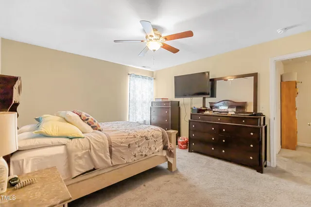 a bedroom with a bed and a television