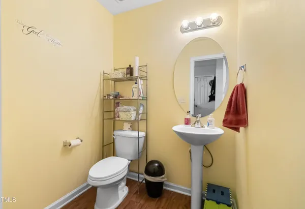 a bathroom with a sink mirror and toilet
