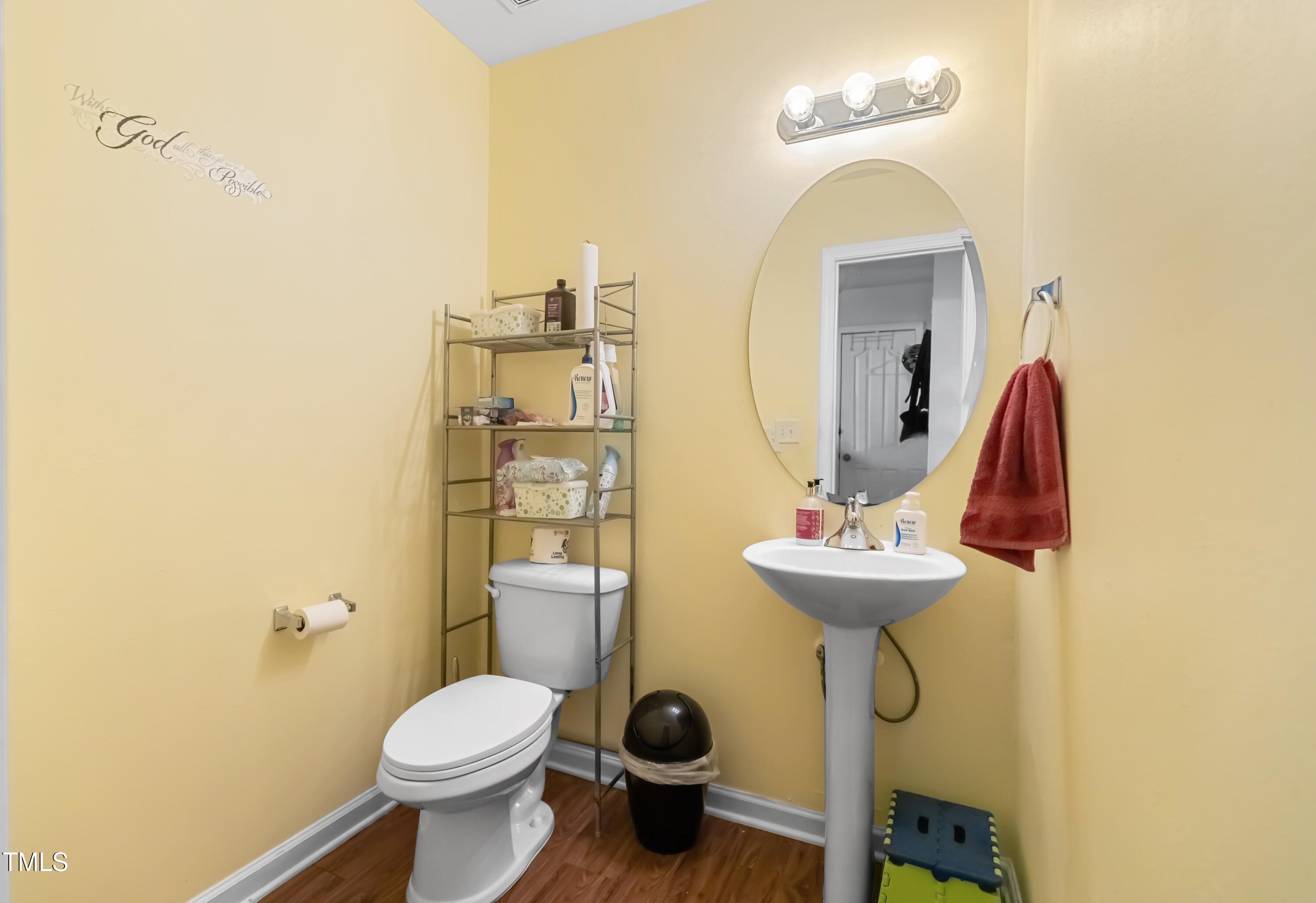 131 Botanical Court Bunnlevel, NC 28323 - Photo 13 of 18 a bathroom with a sink mirror and toilet