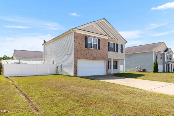a front view of a house with a yard