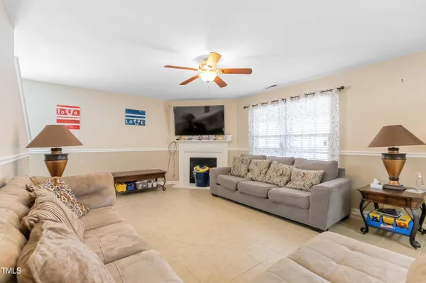 a living room with furniture flat screen tv and a fireplace