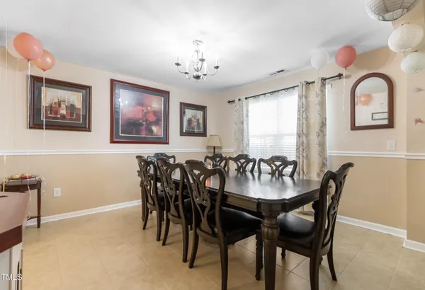 a view of a dining room with furniture and chandelier