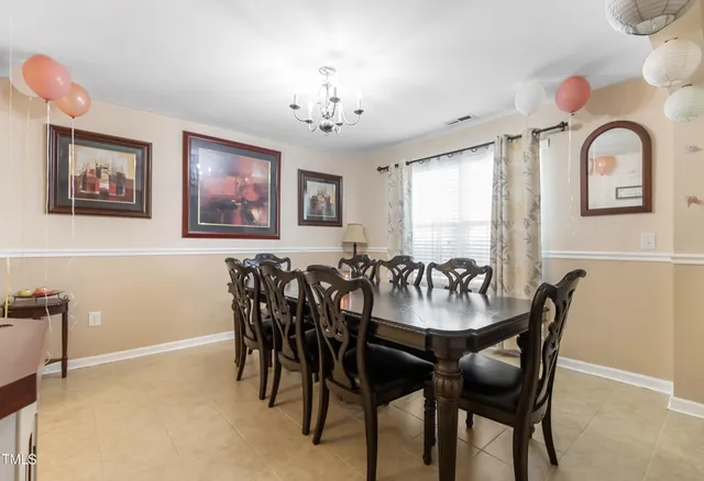a view of a dining room with furniture and chandelier