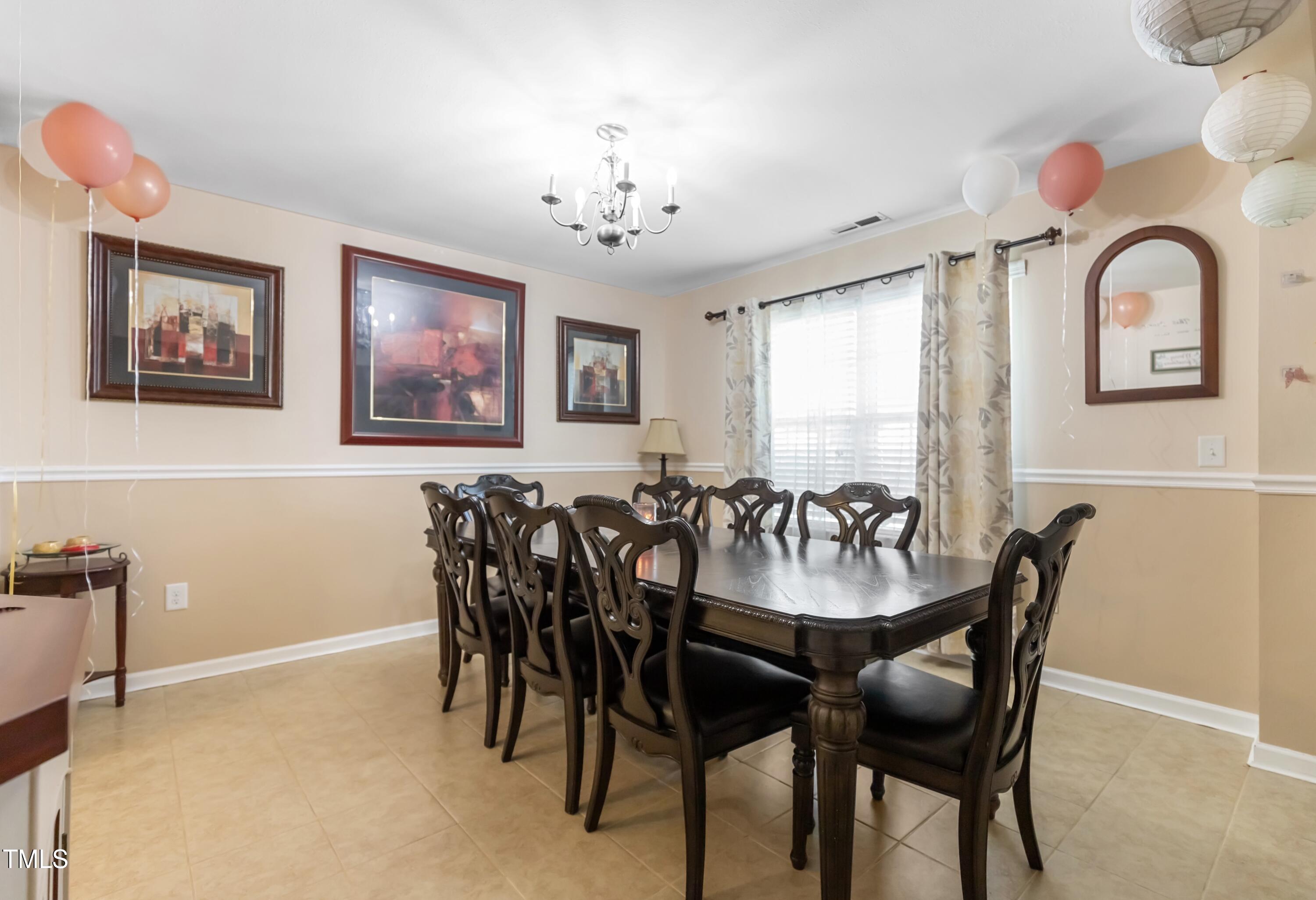 131 Botanical Court Bunnlevel, NC 28323 - Photo 5 of 18 a view of a dining room with furniture and chandelier