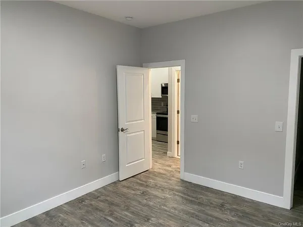 an empty room with wooden floor and closet