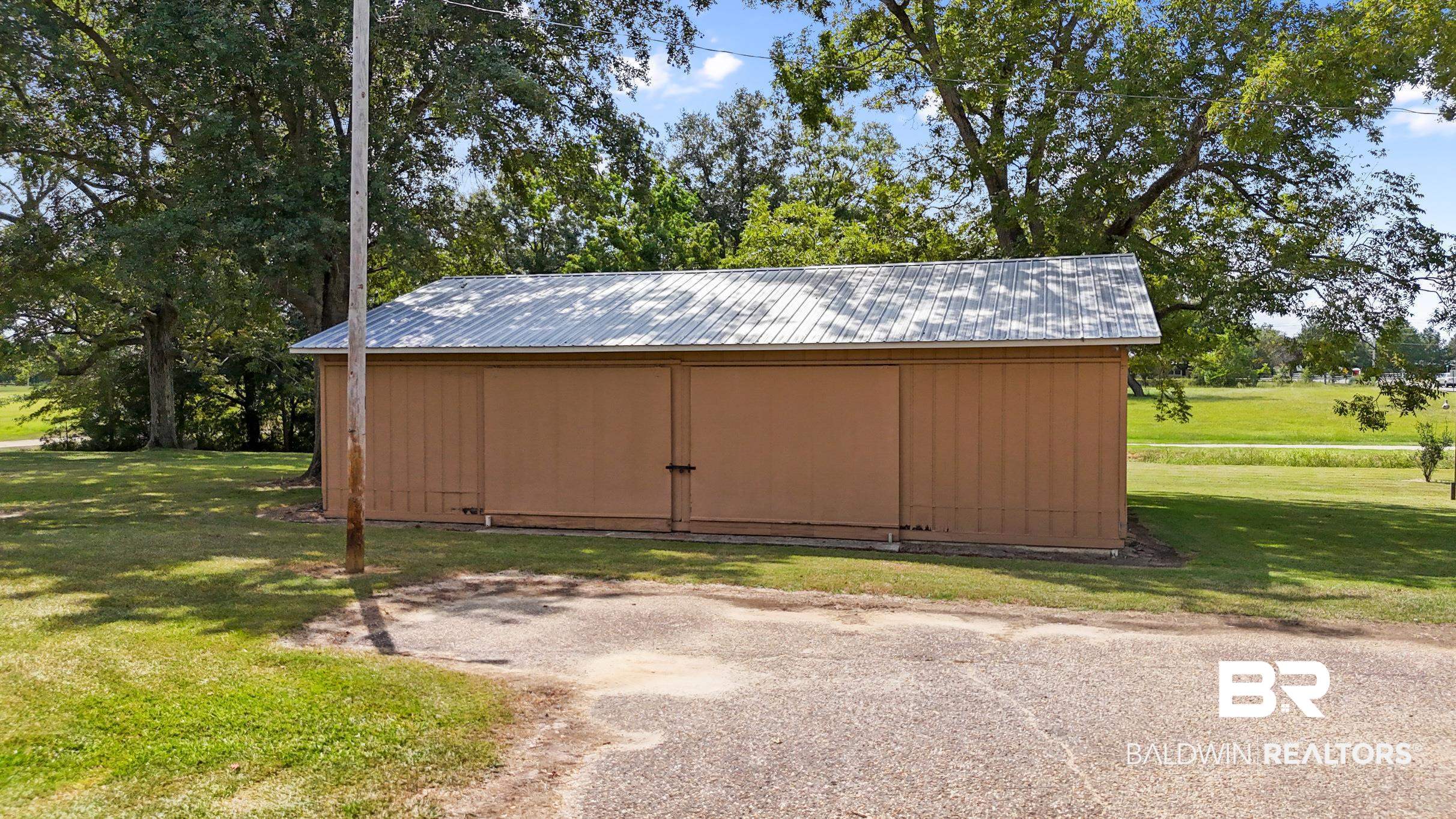 15600 Fackler Road Loxley, AL 36551 - Photo 31 of 51 View of outbuilding featuring a lawn