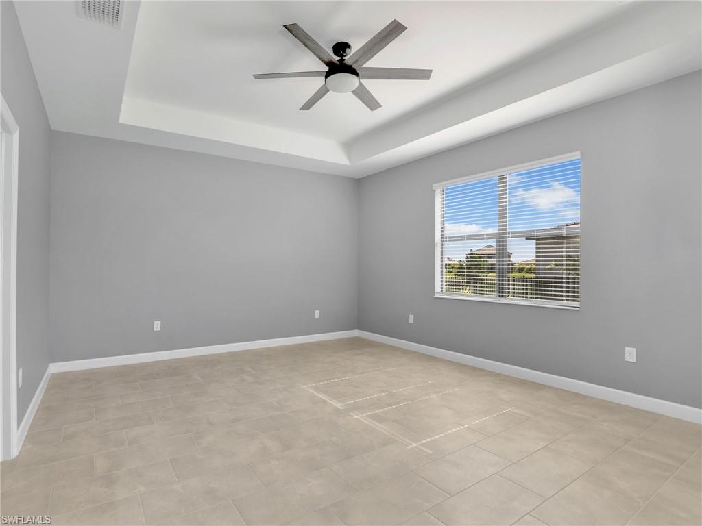 11391 Canopy Loop Fort Myers, FL 33913 - Photo 13 of 43 Primary Bedroom with a tray ceiling, a ceiling fan, and baseboards
