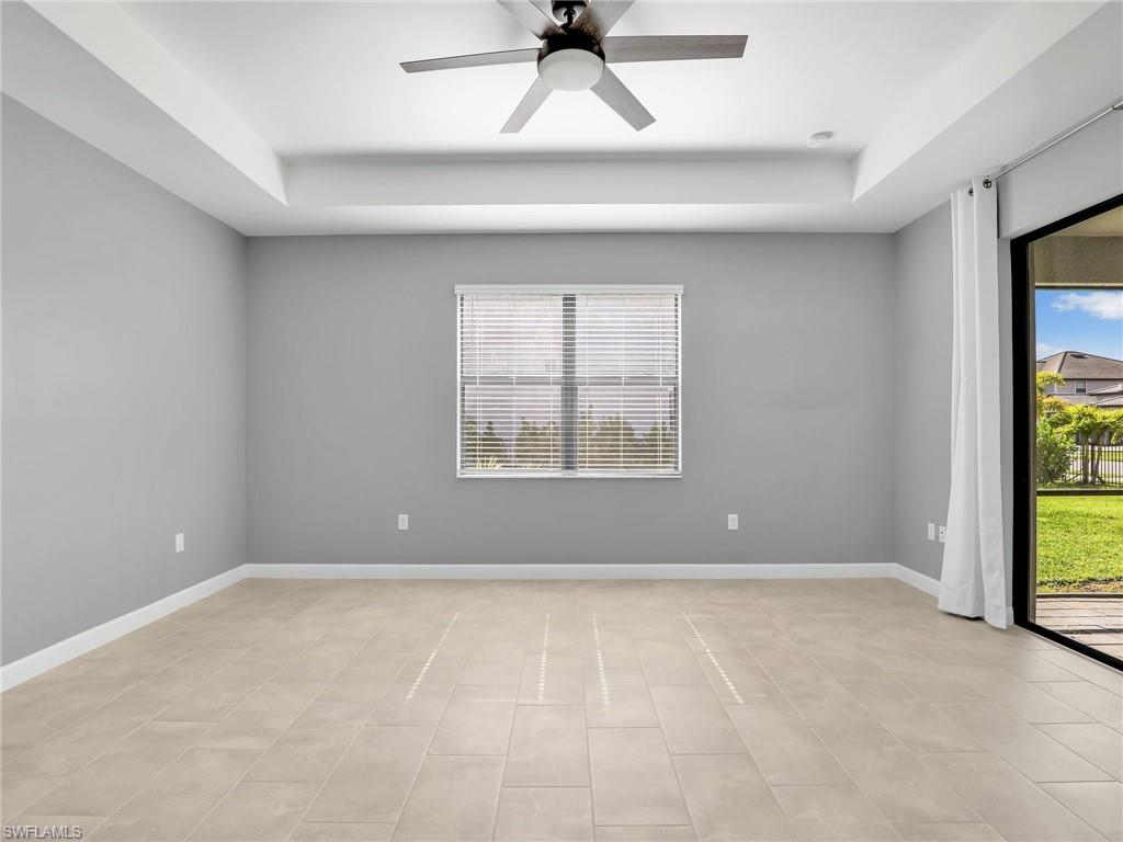 11391 Canopy Loop Fort Myers, FL 33913 - Photo 14 of 43 Primarry Bedroom with a tray ceiling, a ceiling fan, baseboards, and light tile patterned floors