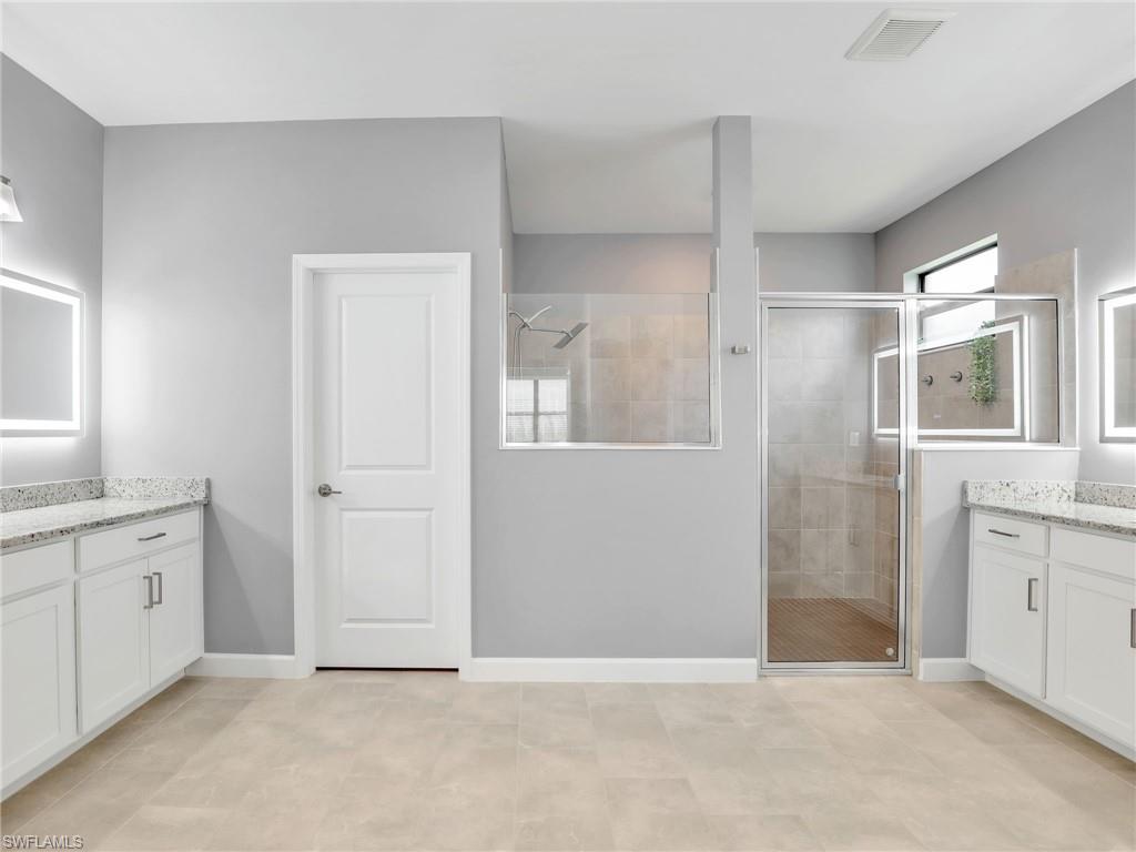 11391 Canopy Loop Fort Myers, FL 33913 - Photo 16 of 43 Full bath with a shower stall, two vanities, and baseboards