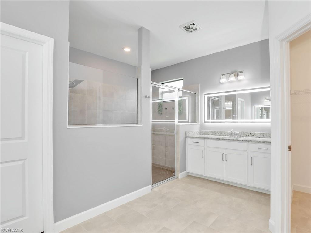 11391 Canopy Loop Fort Myers, FL 33913 - Photo 17 of 43 Full bathroom with a stall shower, vanity, and baseboards