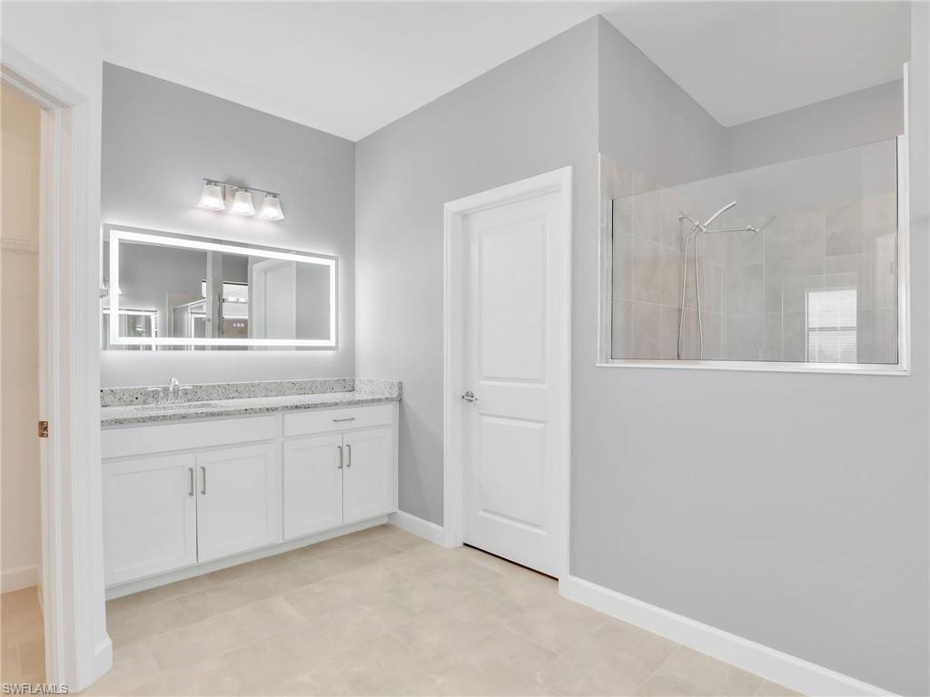 11391 Canopy Loop Fort Myers, FL 33913 - Photo 18 of 43 Full bath with a walk in shower, vanity, and baseboards