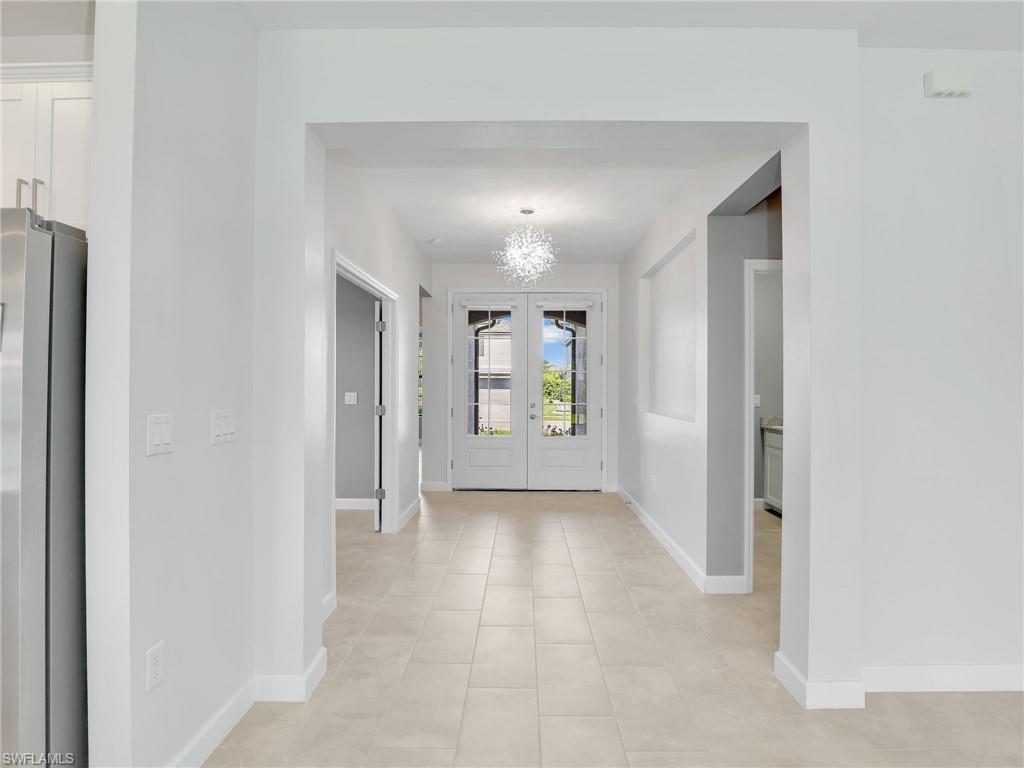 11391 Canopy Loop Fort Myers, FL 33913 - Photo 3 of 43 Entryway featuring baseboards, a chandelier, and light tile patterned floors