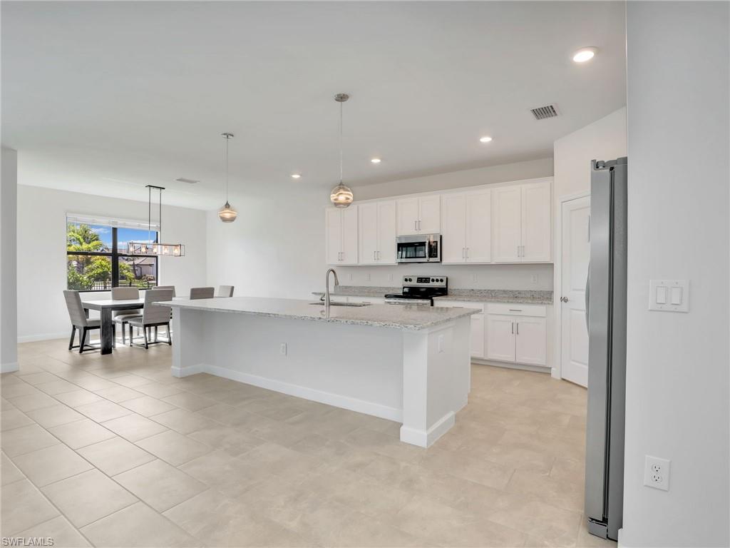 11391 Canopy Loop Fort Myers, FL 33913 - Photo 8 of 43 Kitchen featuring appliances with stainless steel finishes, white cabinets, baseboards, a sink, and recessed lighting