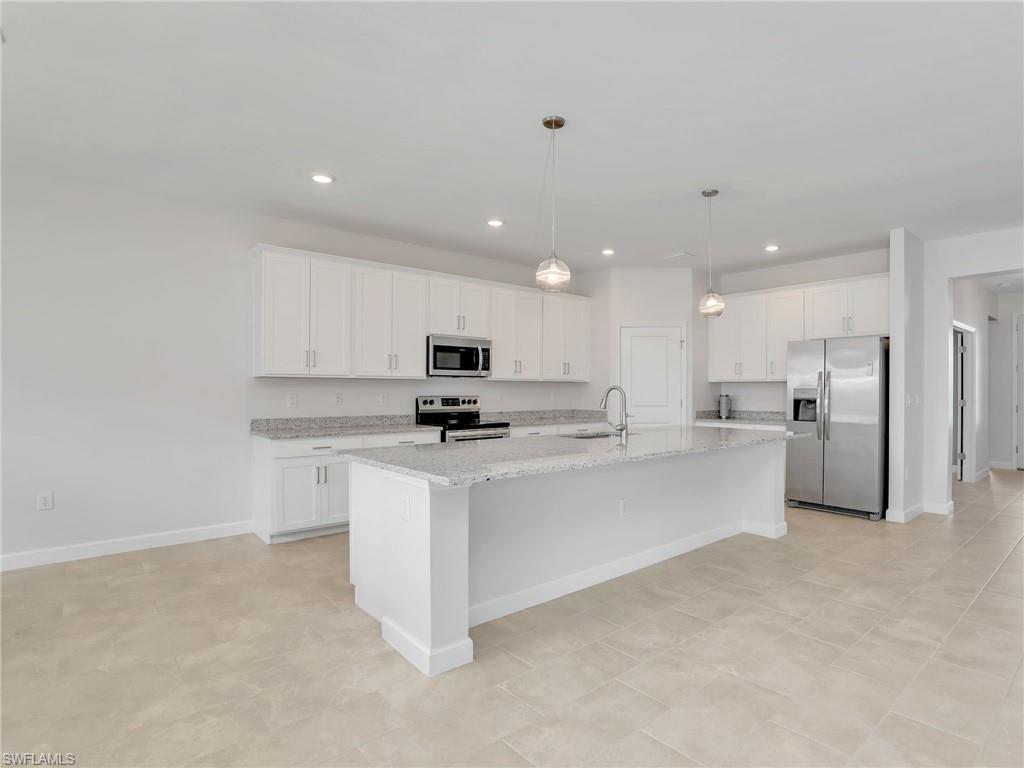 11391 Canopy Loop Fort Myers, FL 33913 - Photo 10 of 43 Kitchen with appliances with stainless steel finishes, a sink, white cabinetry, an island with sink, and recessed lighting