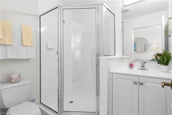 a bathroom with a shower a sink and a mirror