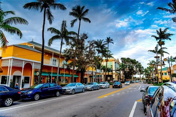 a city street lined with buildings and cars