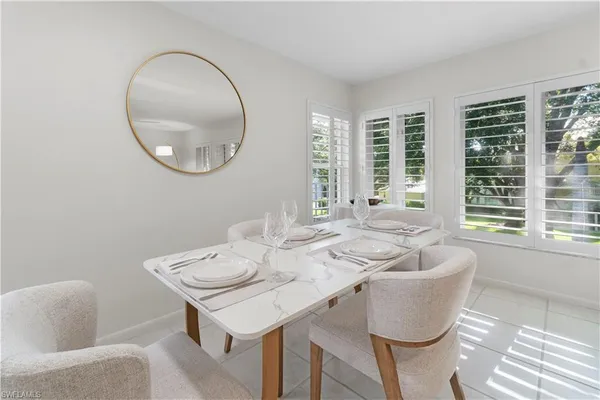 a view of a dining room with furniture and a large window