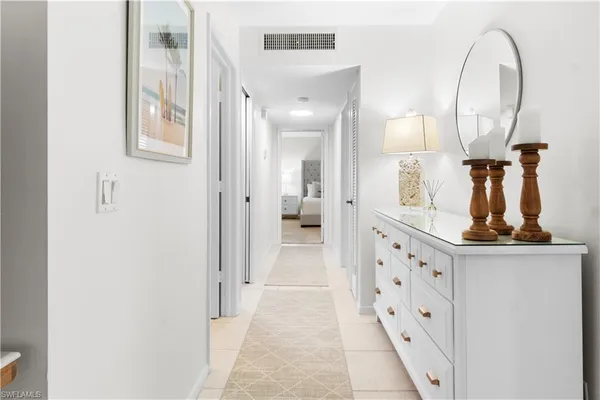 a view of a mirror light fixtures and entryway