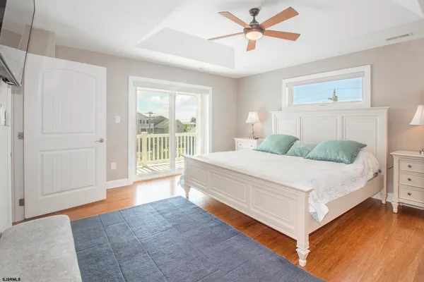 a spacious bedroom with a bed and a chandelier