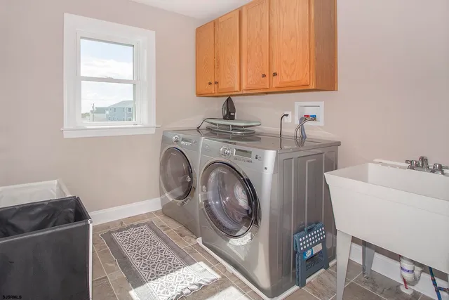 a spacious bedroom with a bed and a chandelier