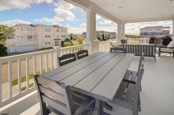 a view of a balcony with chairs and wooden floor