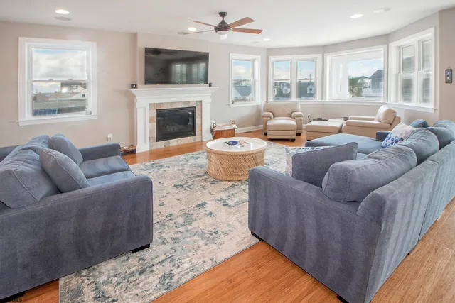 a living room with furniture wooden floor and a flat screen tv