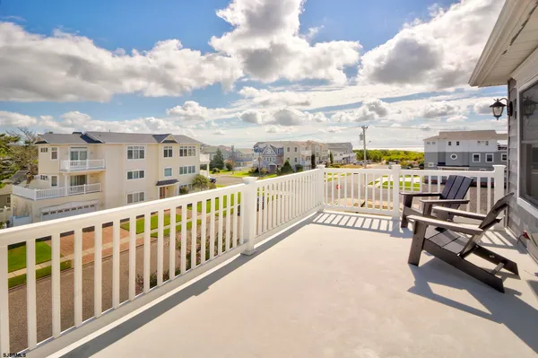 a view of a balcony with furniture