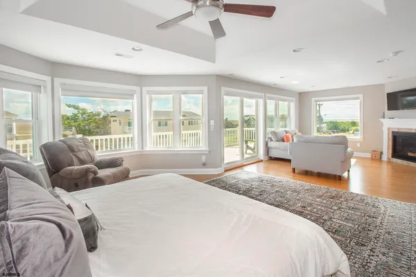 a spacious bedroom with a large bed and a large window