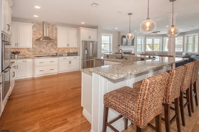 a view of a dining room with furniture wooden floor and chandelier