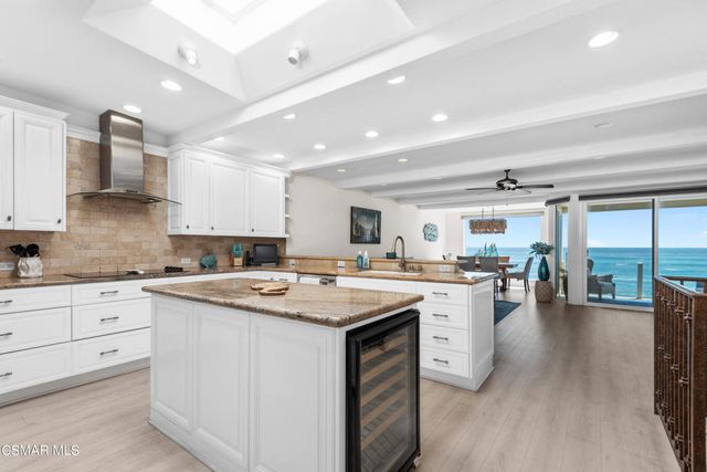 a kitchen with appliances a sink and cabinets