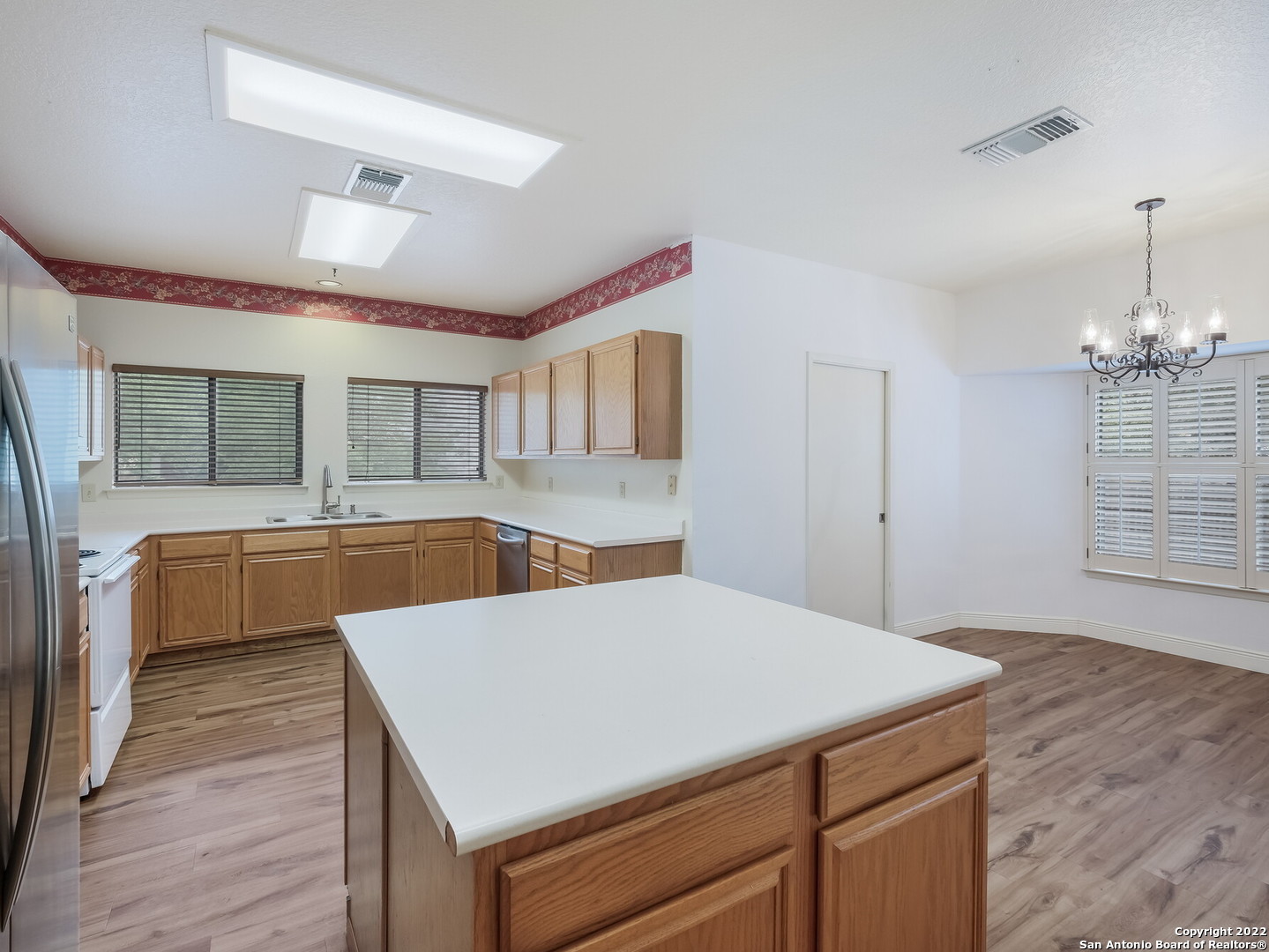 9231 Linbrooke San Antonio, TX 78250 - Photo 13 of 28 a kitchen with a stove a sink and a refrigerator