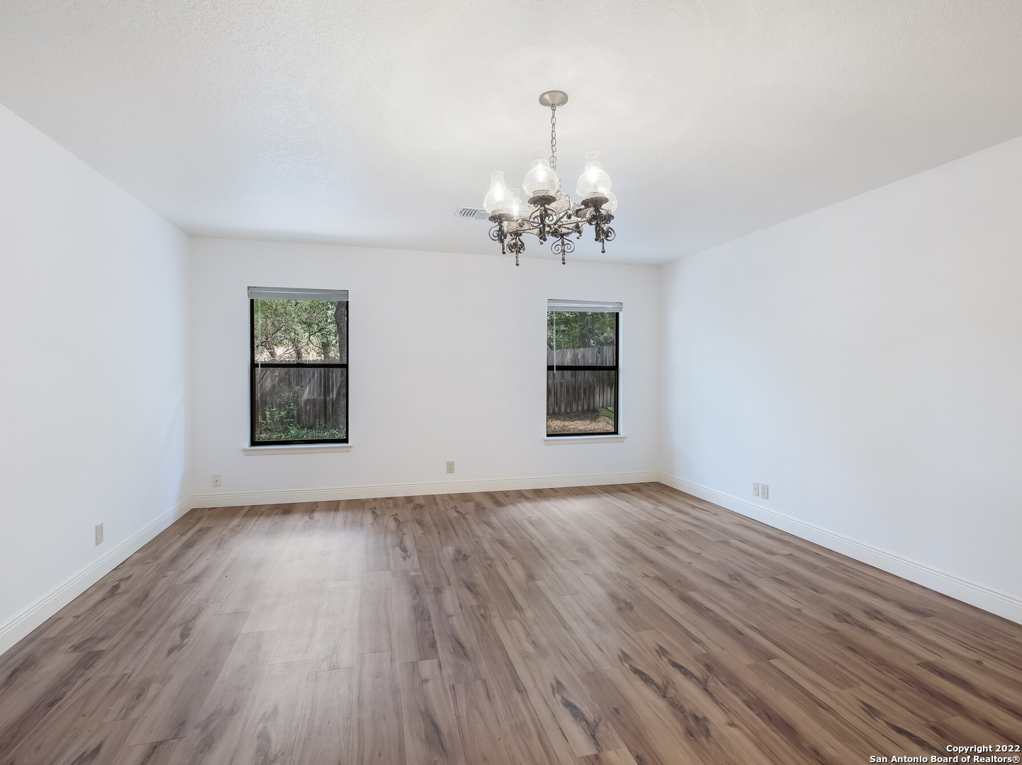 9231 Linbrooke San Antonio, TX 78250 - Photo 16 of 28 a view of an empty room with a window and wooden floor