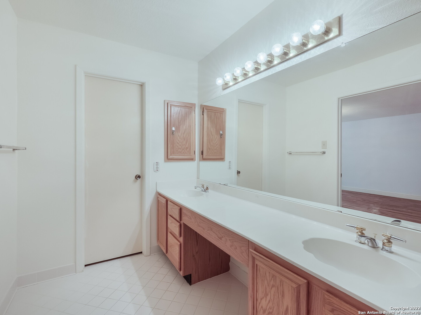 9231 Linbrooke San Antonio, TX 78250 - Photo 20 of 28 a bathroom with a sink double vanity and a mirror
