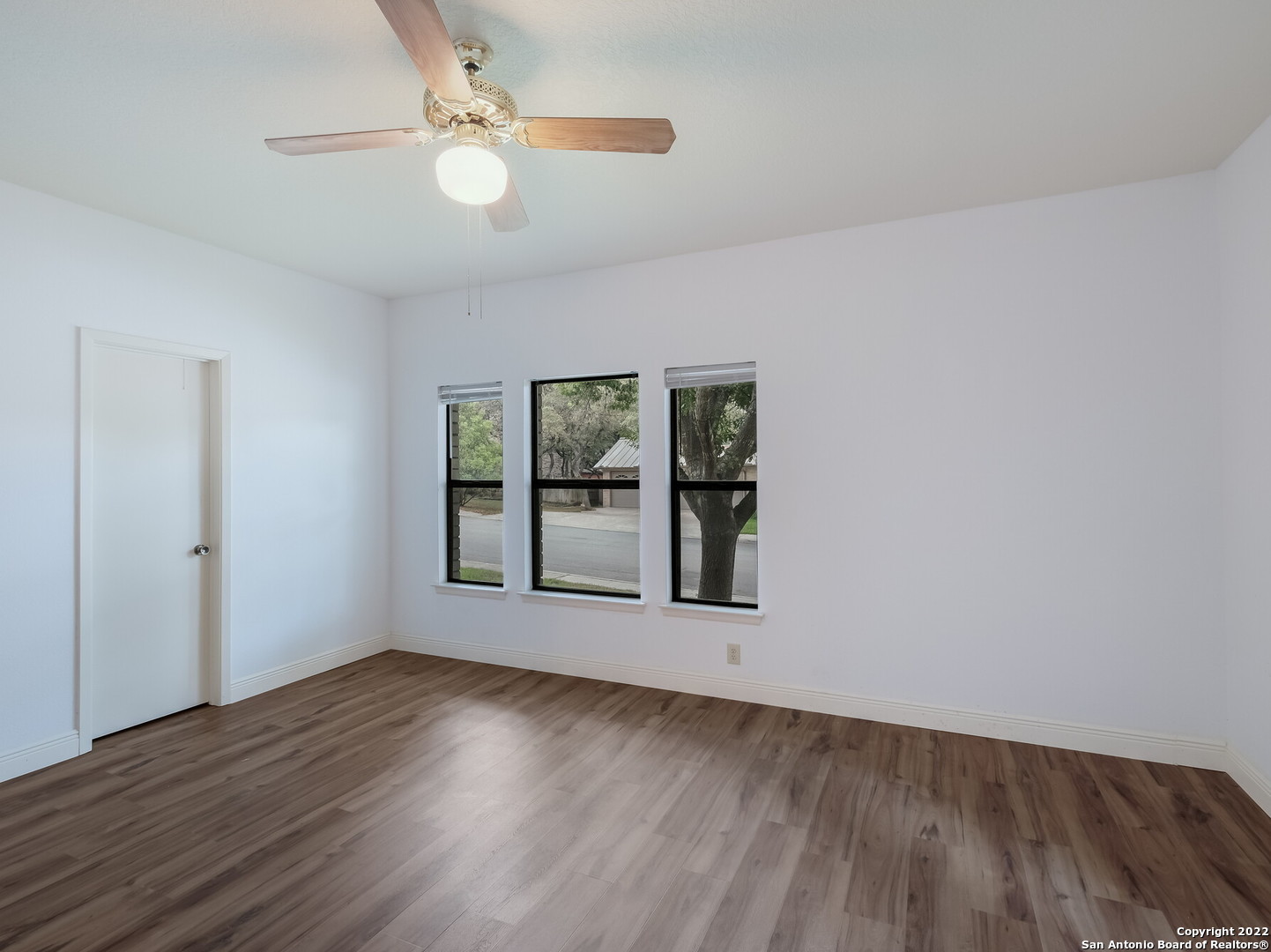 9231 Linbrooke San Antonio, TX 78250 - Photo 22 of 28 wooden floor in an empty room with a window