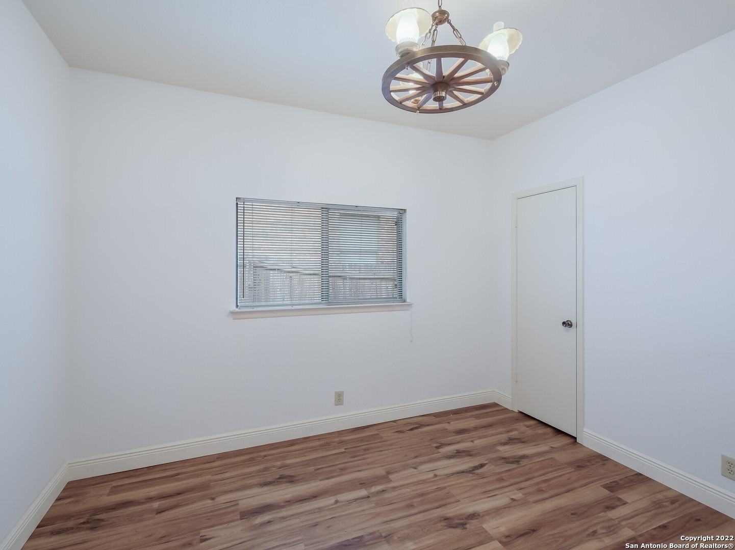 9231 Linbrooke San Antonio, TX 78250 - Photo 23 of 28 a view of an empty room with wooden floor