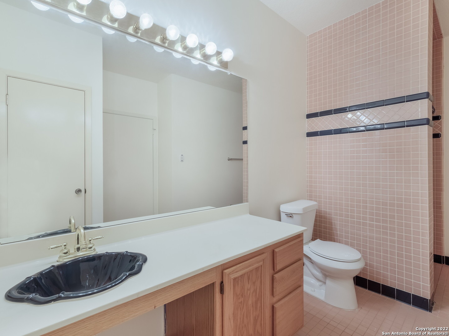 9231 Linbrooke San Antonio, TX 78250 - Photo 25 of 28 a bathroom with a sink a toilet and shower
