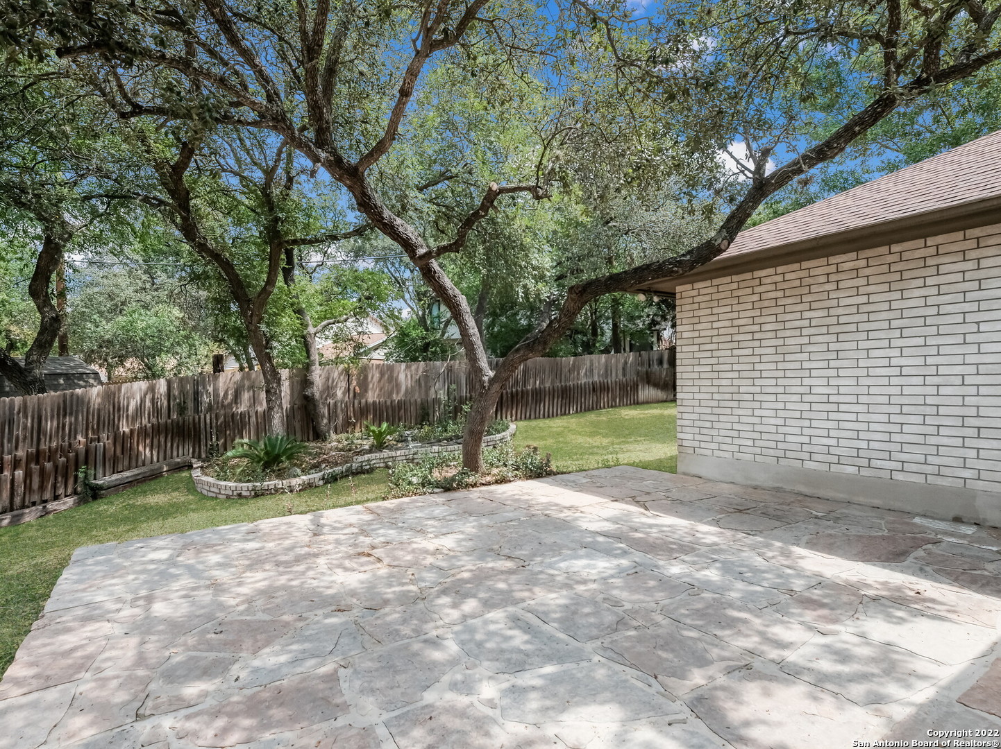 9231 Linbrooke San Antonio, TX 78250 - Photo 26 of 28 a view of a yard with plants and trees