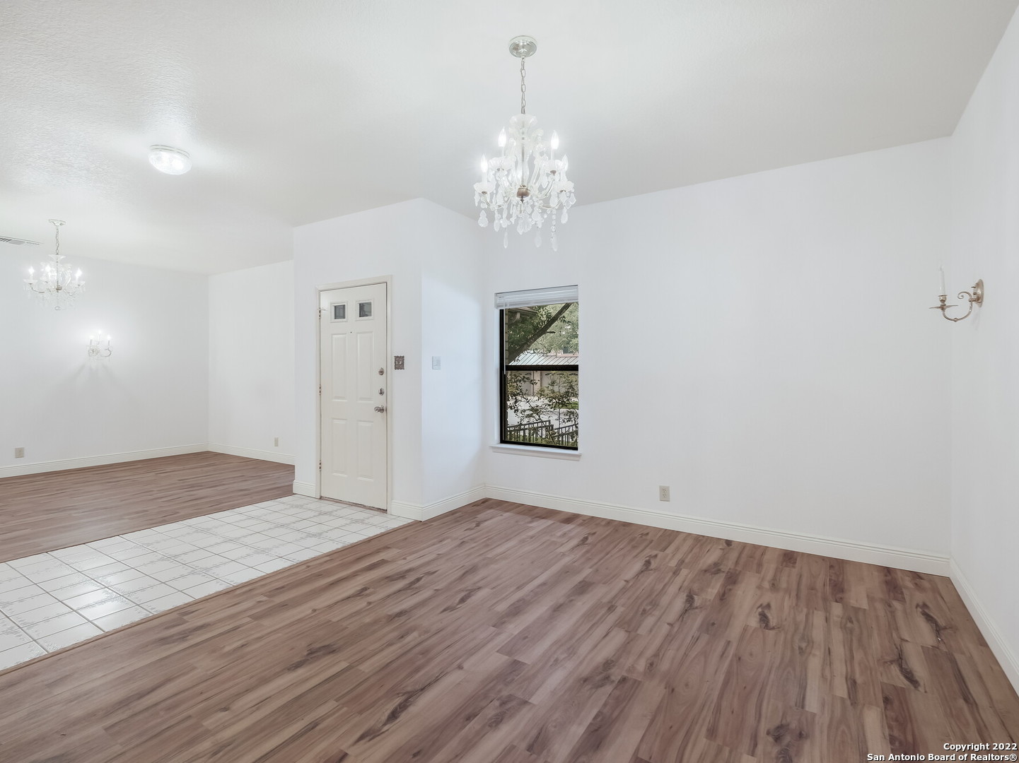 9231 Linbrooke San Antonio, TX 78250 - Photo 6 of 28 wooden floor in an empty room with a window