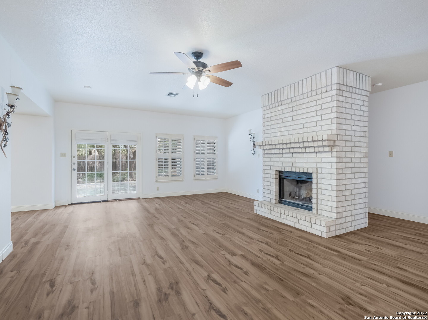 9231 Linbrooke San Antonio, TX 78250 - Photo 8 of 28 a view of empty room with wooden floor and fireplace