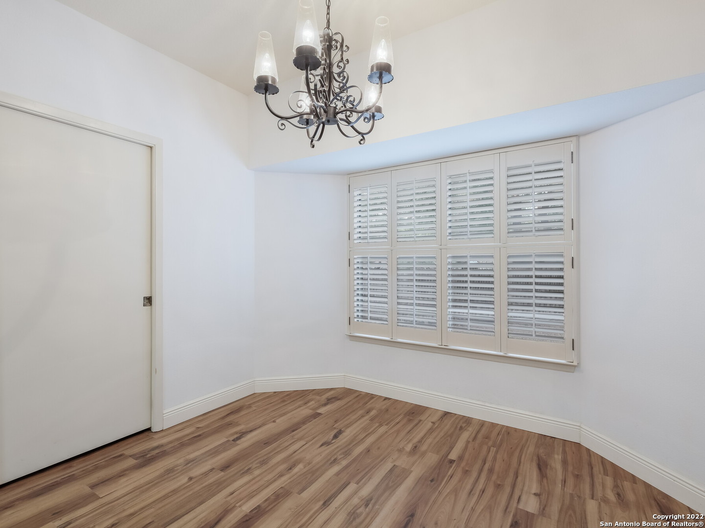 9231 Linbrooke San Antonio, TX 78250 - Photo 10 of 28 a view of an empty room with wooden floor and a window