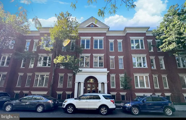 a car parked in front of a brick house