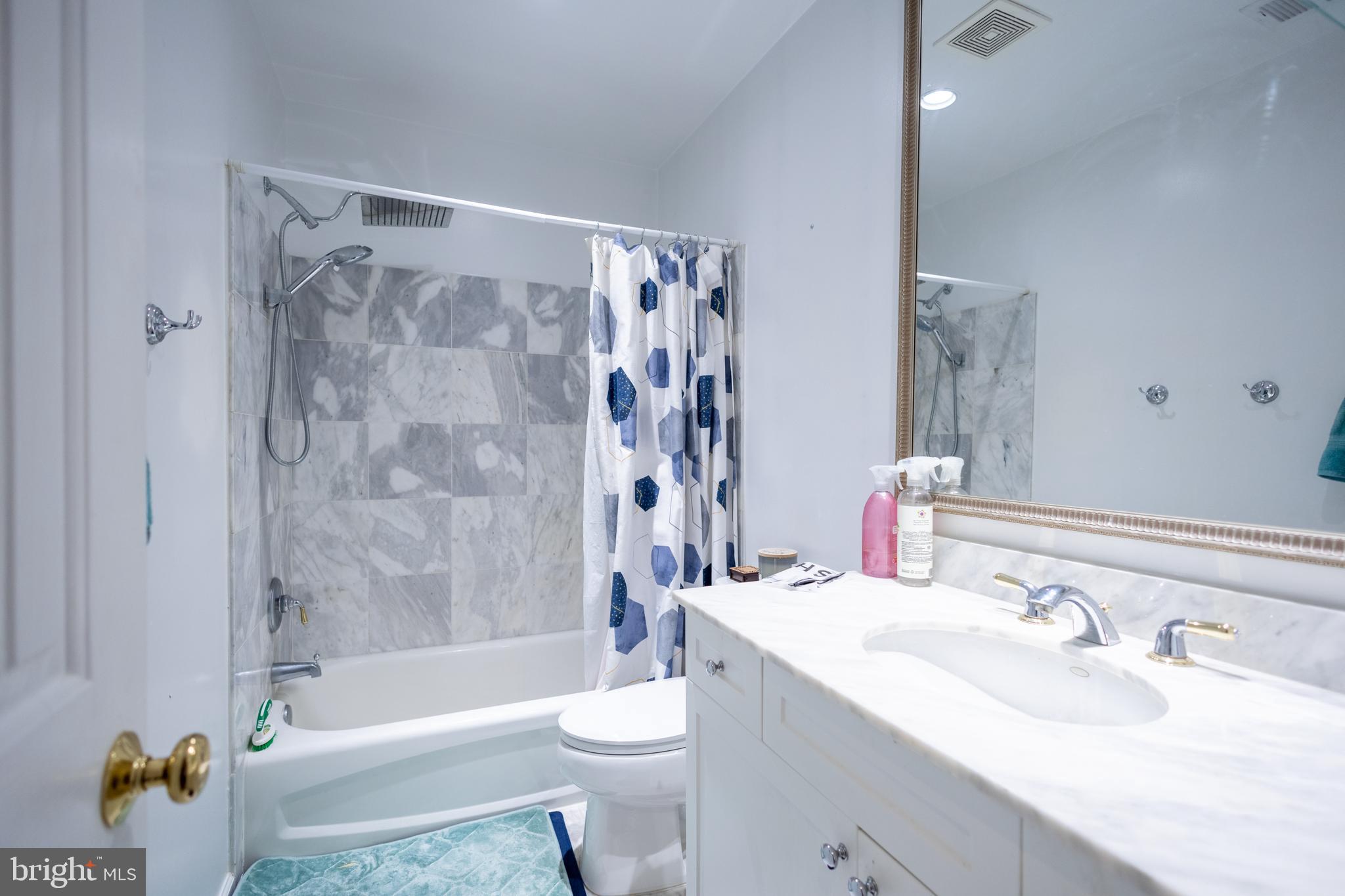1520 O Street Northwest, Unit 104 Washington, DC 20005 - Photo 11 of 15 a bathroom with a sink a toilet a mirror a bathtub and shower